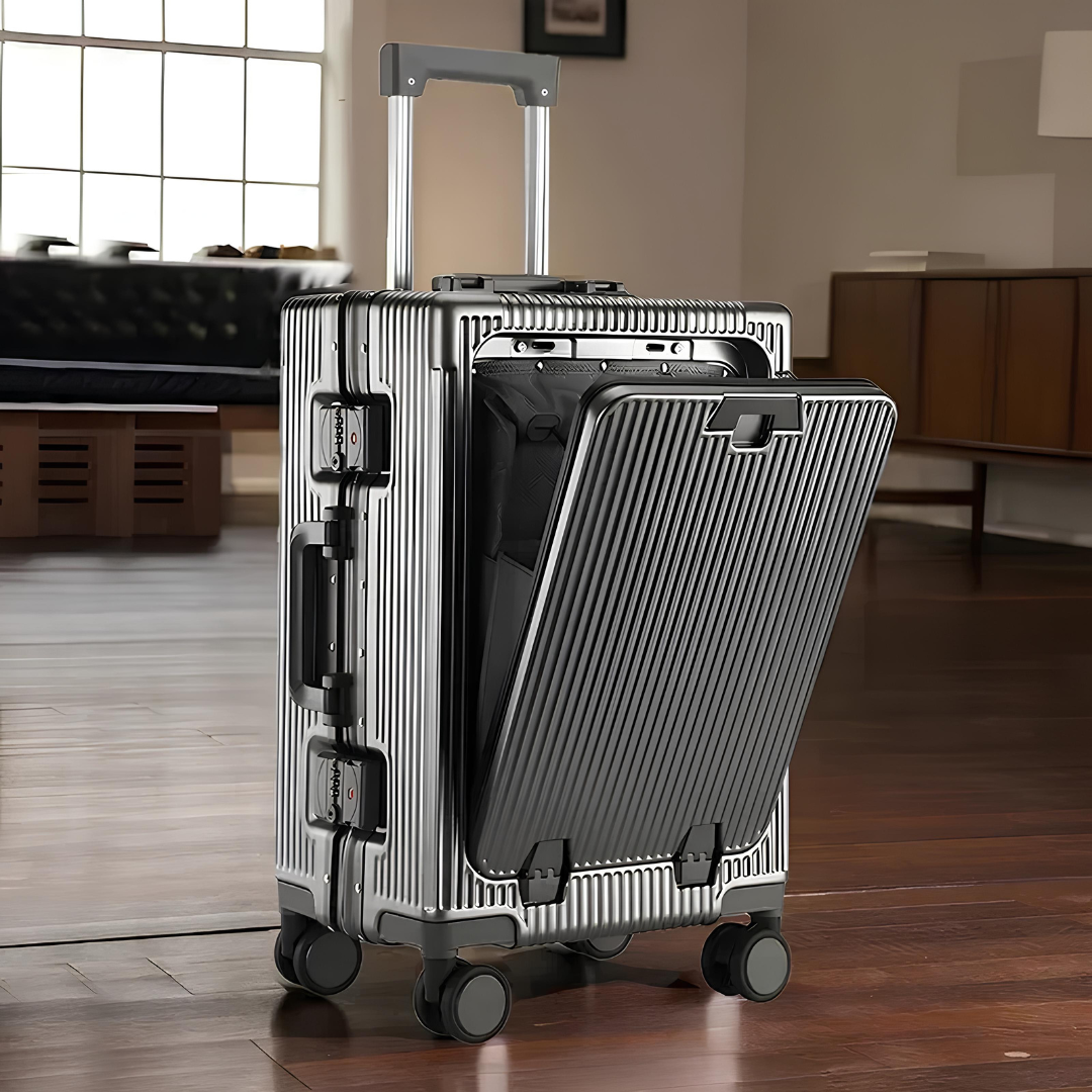 Silver hard-shell suitcase placed in an elegant interior, showcasing its sophisticated design and practical front-opening feature.